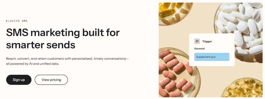 Hero banner with the headline 'SMS marketing built for smarter sends' and two CTA buttons; beige background with a pill collage on the right.